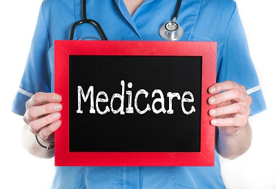 nurse holding a medicare sign